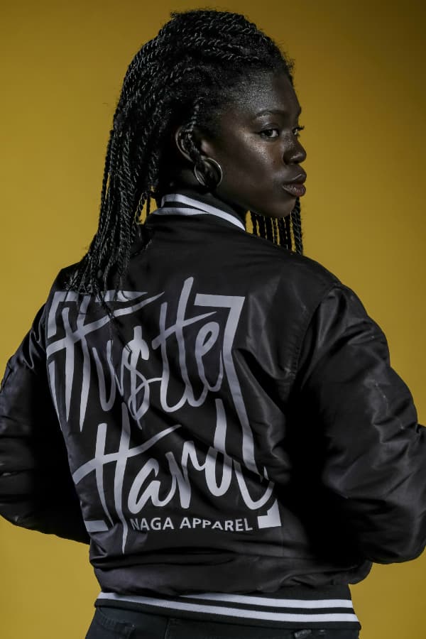 j mula with orange shirt and cap on the beach