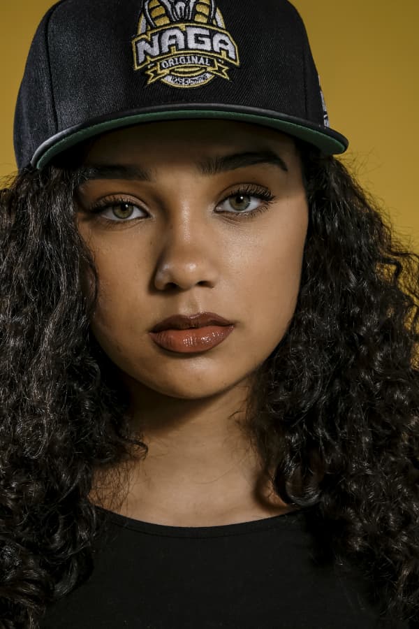 j mula posing with graffiti in background